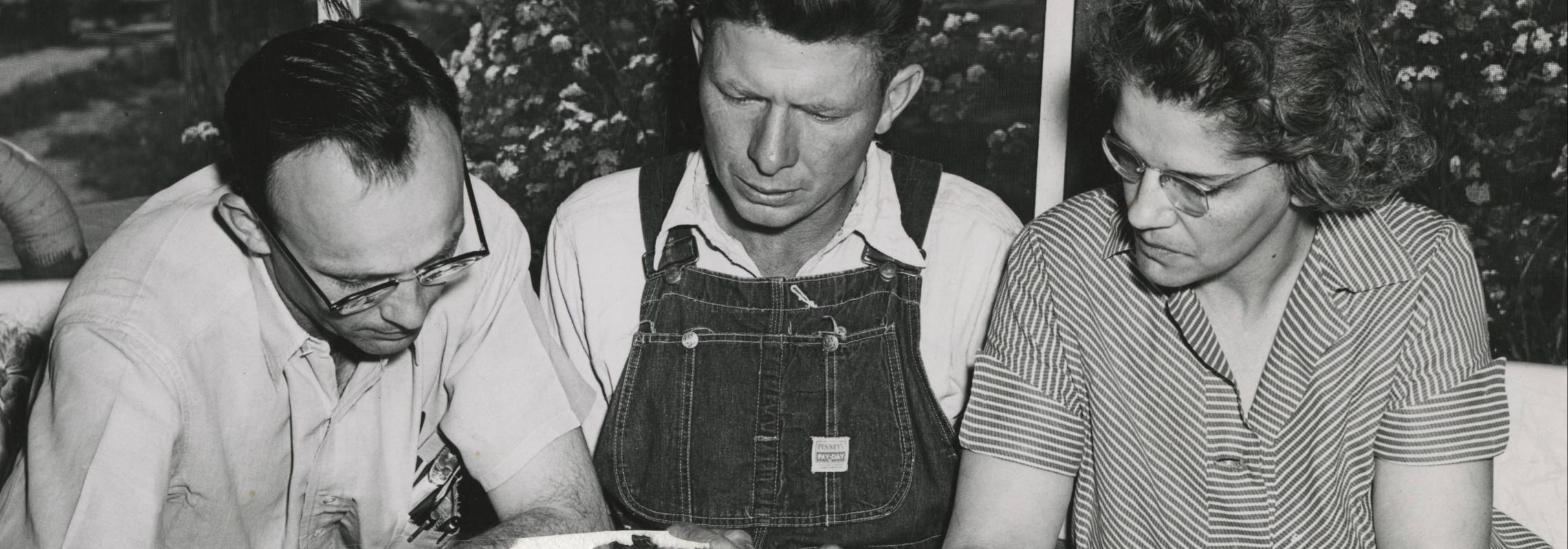 Missouri Ruralist photograph "Production records help Bill Deichman of Laddonia to culll poor producers out of his milking line."