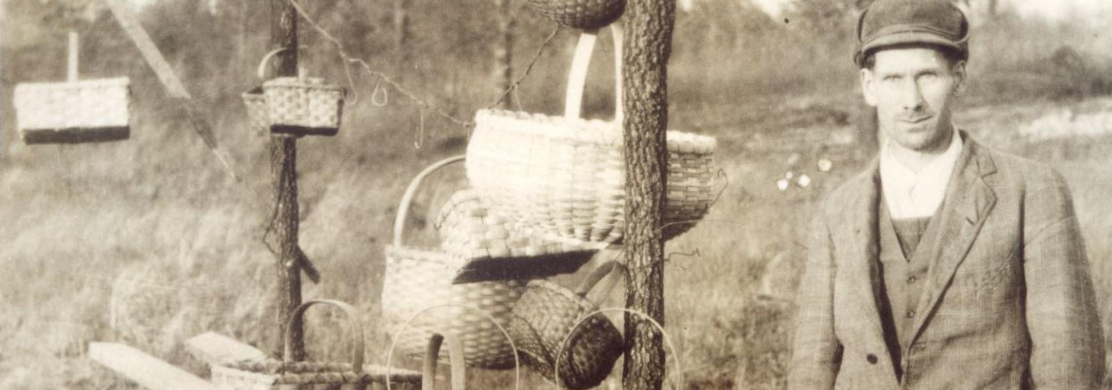 Henry J. Childers showcasing some of his more elaborate baskets. 