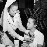 Program title with SHSMO logo and photo of a Black nurse helping a Black blood donor