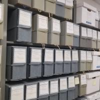 Hollinger archive boxes sit on a shelf