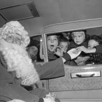 A photograph of Santa with a group of children 