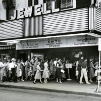 crowd of people waits at doors to Jewell Theatre 