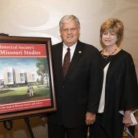 Senator Ron Richard and wife Patty stand by drawing of Center for Missouri Studies